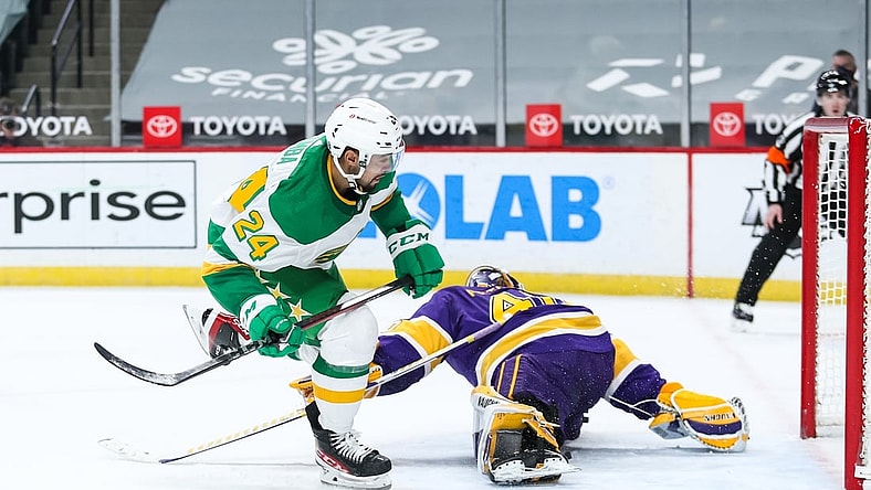 Feb 27, 2021; Saint Paul, Minnesota, USA; Minnesota Wild defenseman Matt Dumba (24) scores a goal against Los Angeles Kings goaltender Calvin Petersen (40) in overtime at Xcel Energy Center. Mandatory Credit: David Berding-USA TODAY Sports