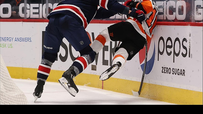 Feb 7, 2021; Washington, District of Columbia, USA; Washington Capitals defenseman Brenden Dillon (4) checks Philadelphia Flyers right wing Travis Konecny (11) while battling for the puck in the third period at Capital One Arena. Mandatory Credit: Geoff Burke-USA TODAY Sports