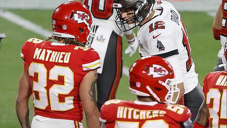 Feb 7, 2020; Tampa, FL, USA; Tampa Bay Buccaneers quarterback Tom Brady (12) talks with Kansas City Chiefs strong safety Tyrann Mathieu (32) during the second quarter of Super Bowl LV at Raymond James Stadium. Mandatory Credit: Kim Klement-USA TODAY Sports