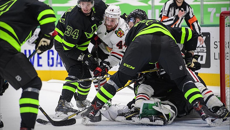 Feb 7, 2021; Dallas, Texas, USA; Dallas Stars right wing Denis Gurianov (34) and defenseman Jamie Oleksiak (2) defend against Chicago Blackhawks defenseman Calvin de Haan (44) during the third period at the American Airlines Center. Mandatory Credit: Jerome Miron-USA TODAY Sports