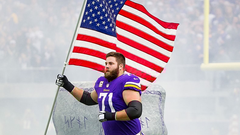 Nov 19, 2017; Minneapolis, MN, USA; Minnesota Vikings offensive lineman Riley Reiff (71) carries the US flag before the game against the Los Angeles Rams at U.S. Bank Stadium. Mandatory Credit: Brad Rempel-USA TODAY Sports