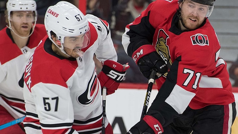 Jan 6, 2019; Ottawa, Ontario, CAN; Carolina Hurricanes defenseman Trevor Van Riemsdyk (57) battles with Ottawa Senators center Chris Tierney (71) in the second period at the Canadian Tire Centre. Mandatory Credit: Marc DesRosiers-USA TODAY Sports