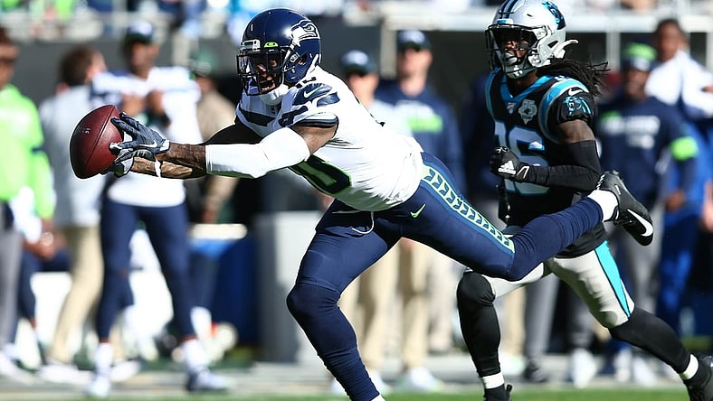 Dec 15, 2019; Charlotte, NC, USA; Seattle Seahawks wide receiver Josh Gordon (10) catches a pass against Carolina Panthers cornerback Donte Jackson (26) during the second quarter at Bank of America Stadium. Mandatory Credit: Jeremy Brevard-USA TODAY Sports