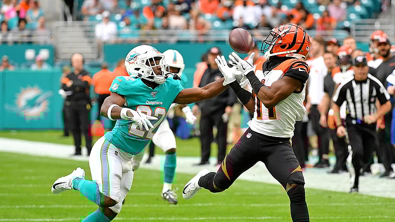Dec 22, 2019; Miami Gardens, Florida, USA; Cincinnati Bengals wide receiver John Ross (11) hauls in a catch in front of Miami Dolphins defensive back Tae Hayes (22) during the first half at Hard Rock Stadium. Mandatory Credit: Steve Mitchell-USA TODAY Sports