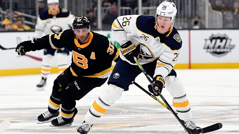 Dec 29, 2019; Boston, Massachusetts, USA; Buffalo Sabres defenseman Rasmus Dahlin (26) skates with the puck up ice in front of Boston Bruins center Patrice Bergeron (37) during the second period at the TD Garden. Mandatory Credit: Brian Fluharty-USA TODAY Sports