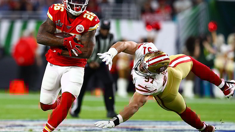 Feb 2, 2020; Miami Gardens, Florida, USA; Kansas City Chiefs running back Damien Williams (26) runs with the ball in the fourth quarter against San Francisco 49ers defensive end Nick Bosa (97) in Super Bowl LIV at Hard Rock Stadium. Mandatory Credit: Matthew Emmons-USA TODAY Sports