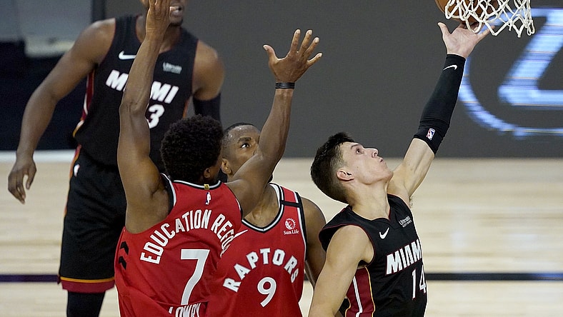 Aug 3, 2020; Lake Buena Vista, USA; Aug 3, 2020; Lake Buena Vista, Florida, USA; Miami Heat's Tyler Herro (14) shoots between Toronto Raptors' Kyle Lowry (7) and Serge Ibaka (9) during the second half of an NBA basketball game in a NBA basketball game at the HP Field House. Mandatory Credit: Ashley Landis/Pool Photo via USA TODAY Sports