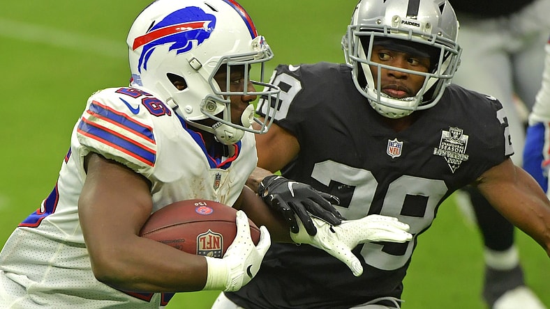 Oct 4, 2020; Paradise, Nevada, USA; Buffalo Bills running back Devin Singletary (26) looks to run past Las Vegas Raiders free safety Lamarcus Joyner (29) during the third quarter at Allegiant Stadium. Mandatory Credit: Stephen R. Sylvanie-USA TODAY Sports