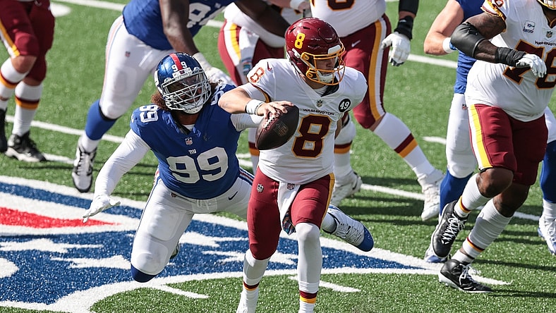 Oct 18, 2020; East Rutherford, New Jersey, USA; Washington Football Team quarterback Kyle Allen (8) scrambles as New York Giants defensive end Leonard Williams (99) pursues during the first half at MetLife Stadium. Mandatory Credit: Vincent Carchietta-USA TODAY Sports
