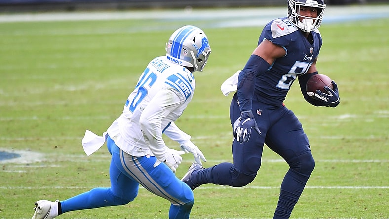 Dec 20, 2020; Nashville, Tennessee, USA; Tennessee Titans tight end Jonnu Smith (81) runs after a catch before being hit by Detroit Lions strong safety Duron Harmon (26) during the first half at Nissan Stadium. Mandatory Credit: Christopher Hanewinckel-USA TODAY Sports