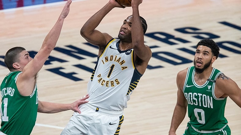 Dec 29, 2020; Indianapolis, Indiana, USA; Indiana Pacers forward T.J. Warren (1) shoots the ball against Boston Celtics forward Amile Jefferson (11) in the third quarter at Bankers Life Fieldhouse. Mandatory Credit: Trevor Ruszkowski-USA TODAY Sports