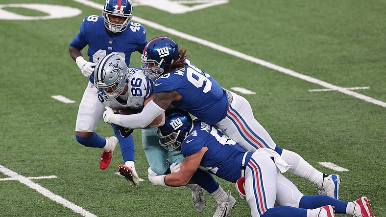 Jan 3, 2021; East Rutherford, NJ, USA; Dallas Cowboys tight end Dalton Schultz (86) is tackled by New York Giants defensive end Leonard Williams (99) and inside linebacker Blake Martinez (54) in the first half at MetLife Stadium. Mandatory Credit: Vincent Carchietta-USA TODAY Sports