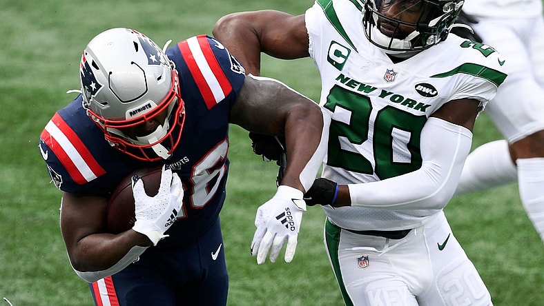Jan 3, 2021; Foxborough, Massachusetts, USA; New England Patriots running back Sony Michel (26) rushes against New York Jets free safety Marcus Maye (20) during the first quarter at Gillette Stadium. Mandatory Credit: Brian Fluharty-USA TODAY Sports