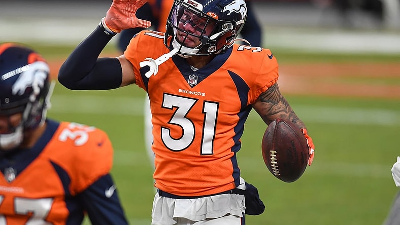 Jan 3, 2021; Denver, Colorado, USA; Denver Broncos free safety Justin Simmons (31) celebrates his interception in the fourth quarter against the Las Vegas Raiders at Empower Field at Mile High. Mandatory Credit: Ron Chenoy-USA TODAY Sports