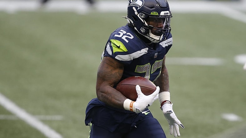 Jan 9, 2021; Seattle, Washington, USA; Seattle Seahawks running back Chris Carson (32) runs the ball against the Los Angeles Rams during the third quarter at Lumen Field. Mandatory Credit: Joe Nicholson-USA TODAY Sports