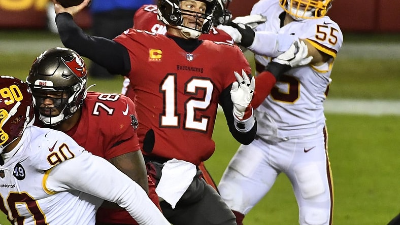 Jan 9, 2021; Landover, Maryland, USA; Tampa Bay Buccaneers quarterback Tom Brady (12) throws a pass as Washington Football Team linebacker Cole Holcomb (55) rushes during the third quarter at FedExField. Mandatory Credit: Brad Mills-USA TODAY Sports