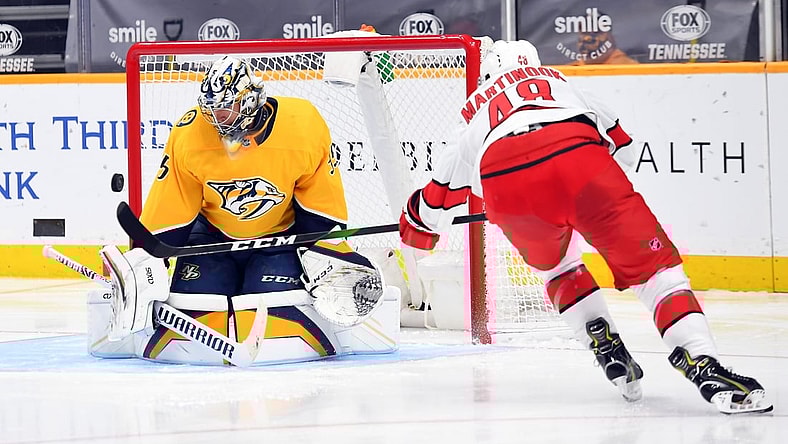 Jan 18, 2021; Nashville, Tennessee, USA; Nashville Predators goaltender Pekka Rinne (35) makes a save on a shot by Carolina Hurricanes left wing Jordan Martinook (48) during the second period at Bridgestone Arena. Mandatory Credit: Christopher Hanewinckel-USA TODAY Sports