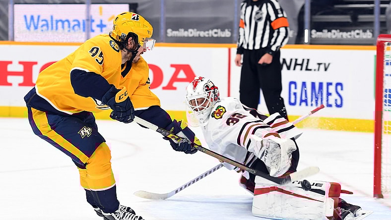 Jan 27, 2021; Nashville, Tennessee, USA; Nashville Predators center Matt Duchene (95) scores the eventual game winner on a shootout shot past Chicago Blackhawks goaltender Kevin Lankinen (32) at Bridgestone Arena. Mandatory Credit: Christopher Hanewinckel-USA TODAY Sports