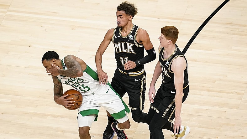 Feb 24, 2021; Atlanta, Georgia, USA; Boston Celtics guard Jeff Teague (55) reacts after getting hit in the face by Atlanta Hawks guard Kevin Huerter (3) during the second half at State Farm Arena. Mandatory Credit: Dale Zanine-USA TODAY Sports