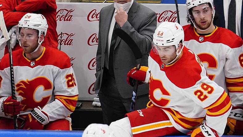 Feb 24, 2021; Toronto, Ontario, CAN; Calgary Flames head coach Geoff Ward (center) on the bench against the Toronto Maple Leafs during the first period at Scotiabank Arena. Mandatory Credit: John E. Sokolowski-USA TODAY Sports