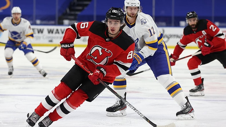 Feb 25, 2021; Buffalo, New York, USA; New Jersey Devils center Jack Hughes (86) looks to make a pass during the first period against the Buffalo Sabres at KeyBank Center. Mandatory Credit: Timothy T. Ludwig-USA TODAY Sports