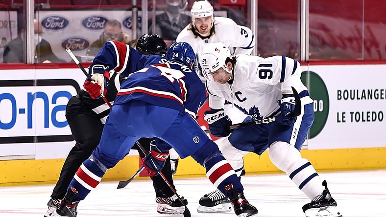 Feb 20, 2021; Montreal, Quebec, CAN; Montreal Canadiens center Nick Suzuki (14) and Toronto Maple Leafs center John Tavares (91) during a first period face-off at Bell Centre. Mandatory Credit: Jean-Yves Ahern-USA TODAY Sports