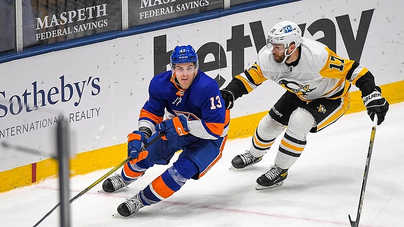 Feb 27, 2021; Uniondale, New York, USA; Pittsburgh Penguins right wing Bryan Rust (17) chases New York Islanders center Mathew Barzal (13) during the third period at Nassau Veterans Memorial Coliseum. Mandatory Credit: Dennis Schneidler-USA TODAY Sports