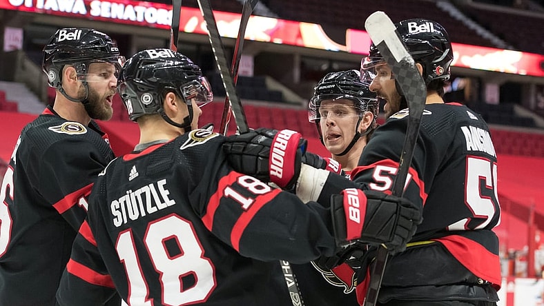 Mar 1, 2021; Ottawa, Ontario, CAN; The  Ottawa Senators celebrate after a goal by center Artem Anisimov (right) the Calgary Flames in the second period against at the Canadian Tire Centre. Mandatory Credit: Marc DesRosiers-USA TODAY Sports