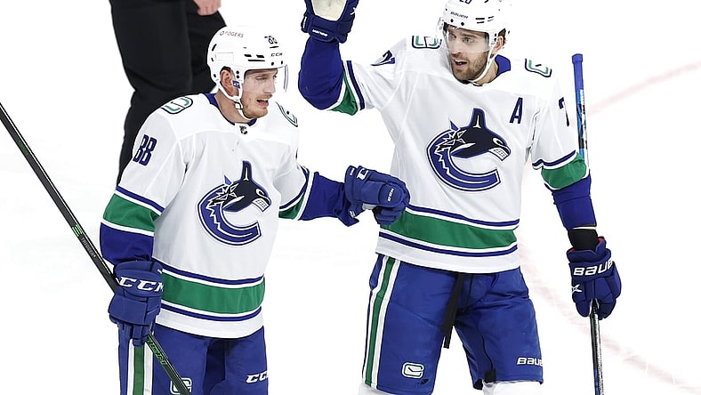 Mar 1, 2021; Winnipeg, Manitoba, CAN;  Vancouver Canucks defenseman Nate Schmidt (88) celebrates his first period goal with Vancouver Canucks center Brandon Sutter (20) against the Winnipeg Jets at Bell MTS Place. Mandatory Credit: James Carey Lauder-USA TODAY Sports