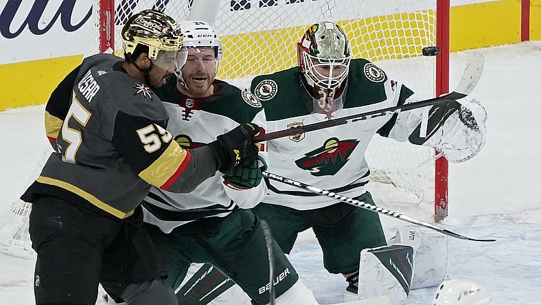 Mar 1, 2021; Las Vegas, Nevada, USA; A shot by the Vegas Golden Knights hits a goal post beside Minnesota Wild goaltender Cam Talbot (33) as Minnesota defenseman Ian Cole (28) guards Vegas right wing Keegan Kolesar (55) during the first period at T-Mobile Arena. Mandatory Credit: John Locher-POOL PHOTOS-USA TODAY Sports