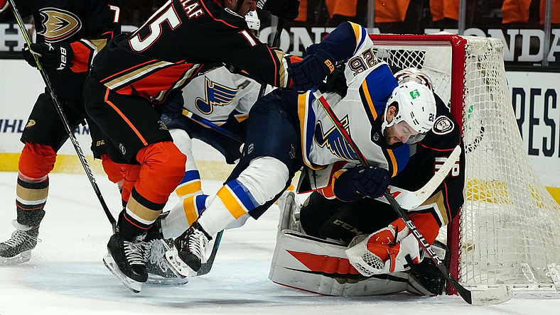 Mar 1, 2021; Anaheim, California, USA; Anaheim Ducks center Ryan Getzlaf (15) and goaltender John Gibson (36) defend the goal against St. Louis Blues left wing Nathan Walker (26) in the first period at Honda Center. Mandatory Credit: Kirby Lee-USA TODAY Sports