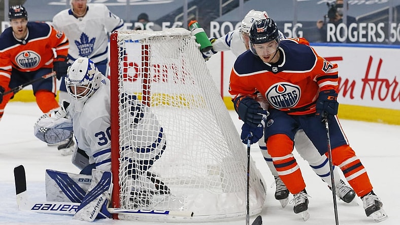 Mar 1, 2021; Edmonton, Alberta, CAN; Edmonton Oilers forward Kailer Yamamoto (56) moves the puck behind Toronto Maple Leafs goaltender Michael Hutchinson (30) during the third period at Rogers Place. Mandatory Credit: Perry Nelson-USA TODAY Sports