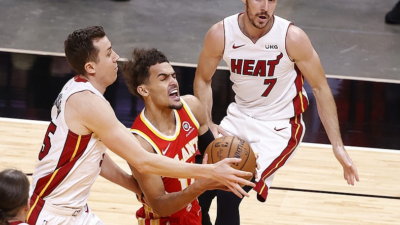Mar 2, 2021; Miami, Florida, USA; Miami Heat forward Duncan Robinson (55) and guard Goarn Dragic (7) defend  Atlanta Hawks guard Trae Young (11) at American Airlines Arena. Mandatory Credit: Rhona Wise-USA TODAY Sports