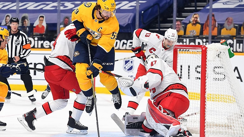 Mar 2, 2021; Nashville, Tennessee, USA; Nashville Predators defenseman Roman Josi (59) jumps after having a shot blocked by Carolina Hurricanes goaltender James Reimer (47) during the first period at Bridgestone Arena. Mandatory Credit: Christopher Hanewinckel-USA TODAY Sports