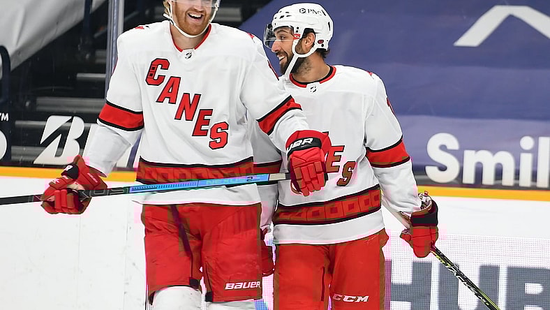 Mar 2, 2021; Nashville, Tennessee, USA; Carolina Hurricanes defenseman Dougie Hamilton (19) and Carolina Hurricanes center Vincent Trocheck (16) react after a goal during the first period against the Nashville Predators at Bridgestone Arena. Mandatory Credit: Christopher Hanewinckel-USA TODAY Sports