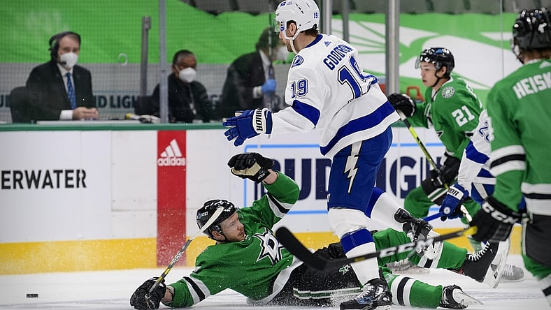 Mar 2, 2021; Dallas, Texas, USA; Dallas Stars defenseman Jamie Oleksiak (2) is tripped up by Tampa Bay Lightning center Barclay Goodrow (19) during the first period at the American Airlines Center. Mandatory Credit: Jerome Miron-USA TODAY Sports