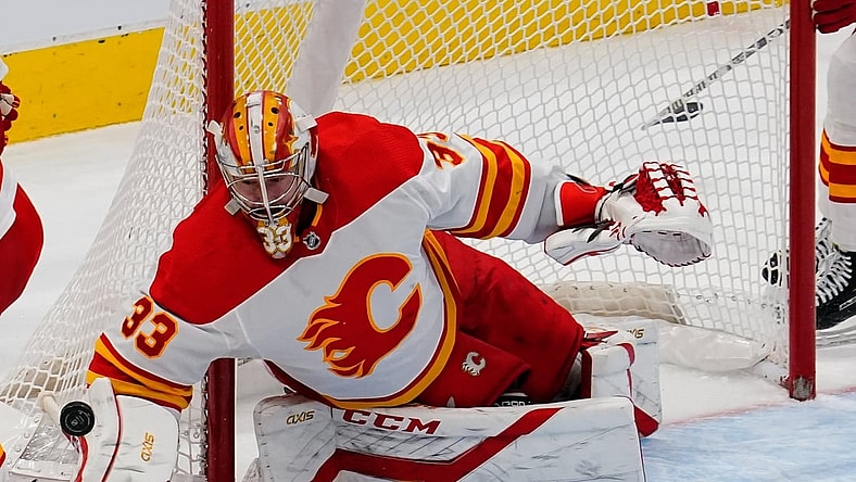 Feb 24, 2021; Toronto, Ontario, CAN; Calgary Flames goaltender David Rittich (33) makes a save against the Toronto Maple Leafs at Scotiabank Arena. Toronto defeated Calgary 2-1 in overtime. Mandatory Credit: John E. Sokolowski-USA TODAY Sports