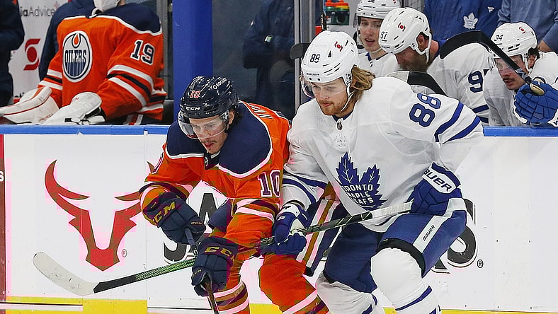 Mar 3, 2021; Edmonton, Alberta, CAN; Toronto Maple Leafs forward William Nylander (88) and Edmonton Oilers forward Joakim Nygard (10) battle for a loose puck during the first period at Rogers Place. Mandatory Credit: Perry Nelson-USA TODAY Sports