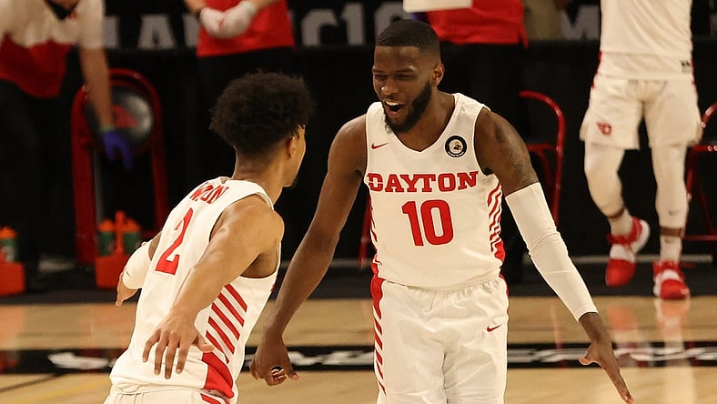 Mar 4, 2021; Richmond, Virginia, USA; Dayton Flyers guard Jalen Crutcher (10) celebrates on the court with Flyers guard Ibi Watson (2) against the Rhode Island Rams in the first half in the second round of the 2021 Atlantic 10 Conference Tournament at Stuart C. Siegel Center. Mandatory Credit: Geoff Burke-USA TODAY Sports