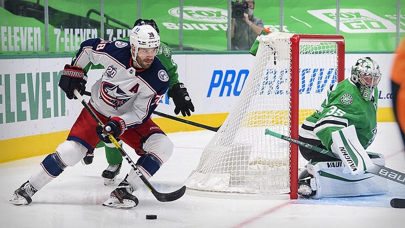 Mar 4, 2021; Dallas, Texas, USA; Columbus Blue Jackets center Boone Jenner (38) skates against the Stars as Dallas Stars goaltender Anton Khudobin (35) defends the goal during the first period at the American Airlines Center. Mandatory Credit: Jerome Miron-USA TODAY Sports