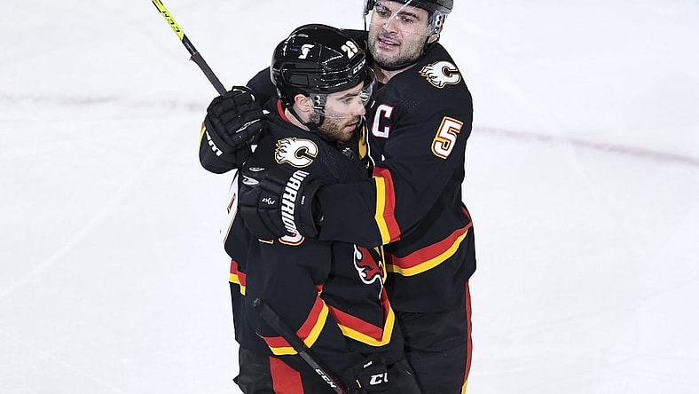 Mar 4, 2021; Calgary, Alberta, CAN; Calgary Flames forward Dillon Dube (29) celebrates his second period goal with defenseman Mark Giordano (5) against the Ottawa Senators at Scotiabank Saddledome. Mandatory Credit: Candice Ward-USA TODAY Sports