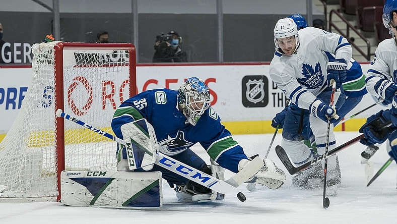 Mar 4, 2021; Vancouver, British Columbia, CAN; Vancouver Canucks goalie Thatcher Demko (35) makes a save on Toronto Maple Leafs forward  Zach Hyman (11) in the first period at Rogers Arena. Mandatory Credit: Bob Frid-USA TODAY Sports