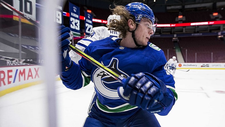 Mar 4, 2021; Vancouver, British Columbia, CAN; Toronto Maple Leafs defenseman Morgan Rielly (44) checks Vancouver Canucks forward Adam Gaudette (96) in the second period at Rogers Arena. Mandatory Credit: Bob Frid-USA TODAY Sports