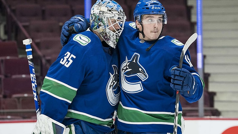 Mar 4, 2021; Vancouver, British Columbia, CAN; Vancouver Canucks goalie Thatcher Demko (35) and forward Jake Virtanen (18) celebrate their victory against the Toronto Maple Leafs in the third period at Rogers Arena. Canucks won 3-1. Mandatory Credit: Bob Frid-USA TODAY Sports