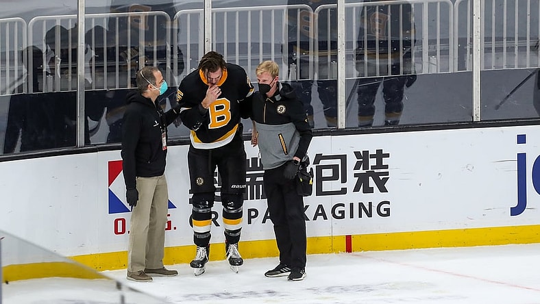 Mar 5, 2021; Boston, Massachusetts, USA; Boston Bruins defenseman Brandon Carlo (25) reacts after suffering an apparent injury against the Washington Capitals during the first period at TD Garden. Mandatory Credit: Paul Rutherford-USA TODAY Sports