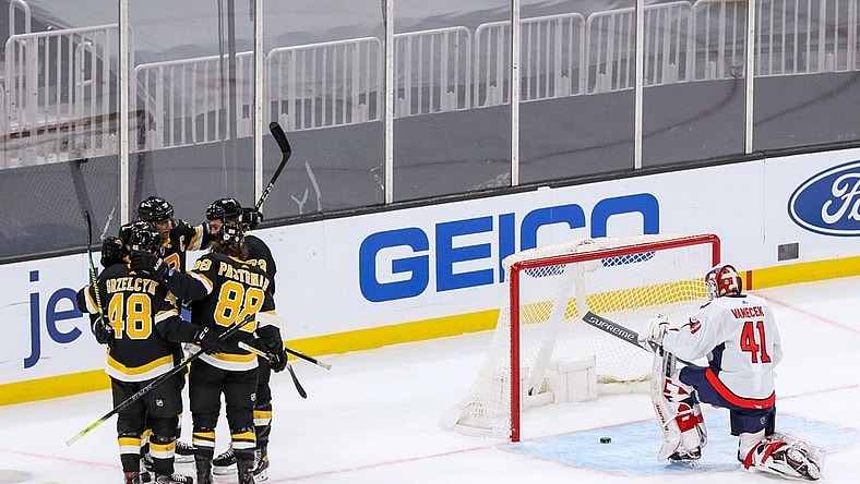 Mar 5, 2021; Boston, Massachusetts, USA; The Boston Bruins celebrate after a goal by left wing Brad Marchand (63) against Washington Capitals goalie Vitek Vanecek (41) during the second period at TD Garden. Mandatory Credit: Paul Rutherford-USA TODAY Sports