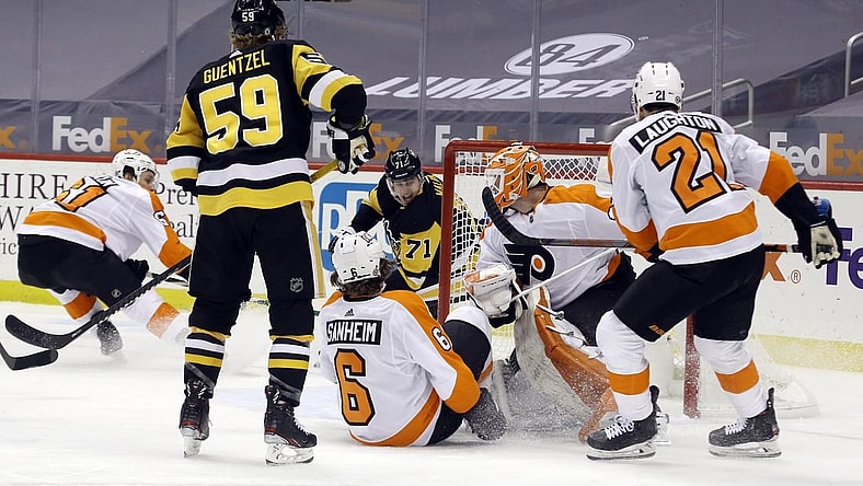 Mar 6, 2021; Pittsburgh, Pennsylvania, USA; Pittsburgh Penguins center Evgeni Malkin (71) scores a goal on a wrap around shot against Philadelphia Flyers goaltender Brian Elliott (37) during the first period at PPG Paints Arena. Mandatory Credit: Charles LeClaire-USA TODAY Sports