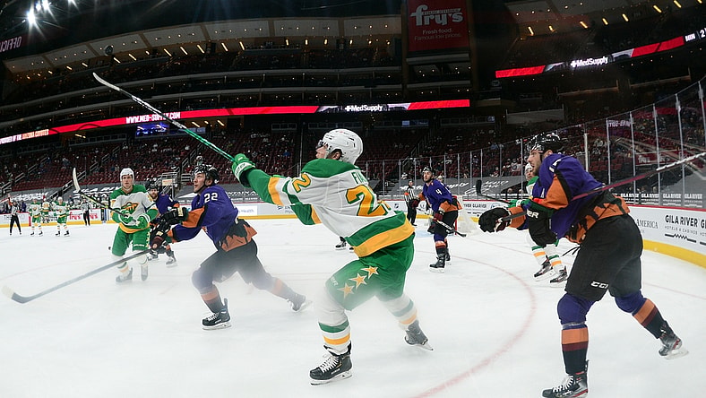 Mar 6, 2021; Glendale, Arizona, USA; Minnesota Wild left wing Kevin Fiala (22) bats down a puck against the Arizona Coyotes during the second period at Gila River Arena. Mandatory Credit: Joe Camporeale-USA TODAY Sports