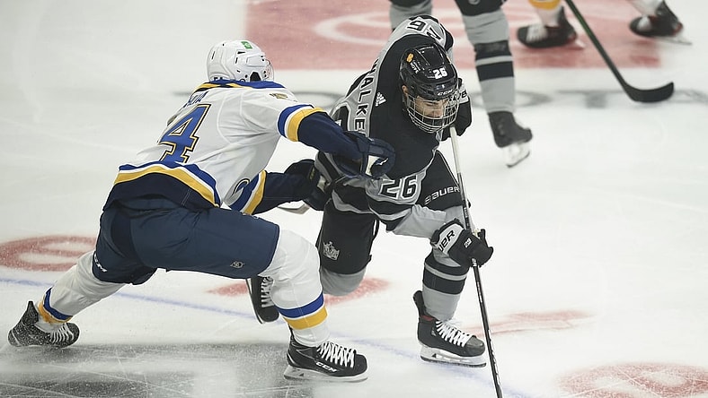 Mar 6, 2021; Los Angeles, California, USA; Los Angeles Kings defenseman Sean Walker (26) moves the puck while defended by St. Louis Blues center Dakota Joshua (54) during the first period at Staples Center. Mandatory Credit: Kelvin Kuo-USA TODAY Sports