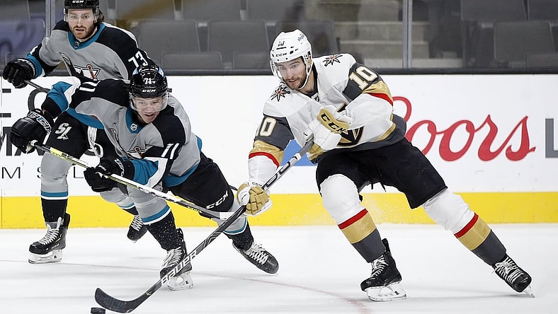 Mar 6, 2021; San Jose, California, USA; Vegas Golden Knights center Nicolas Roy (10) reaches for the puck against San Jose Sharks defenseman Nikolai Knyzhov (71) during the second period at SAP Center at San Jose. Mandatory Credit: Darren Yamashita-USA TODAY Sports